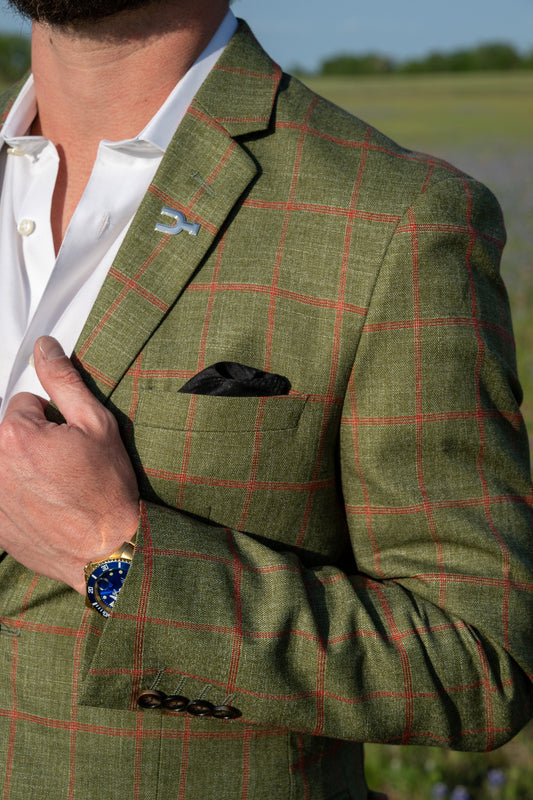 Green checkered jacket worn by a person with a blurred natural background